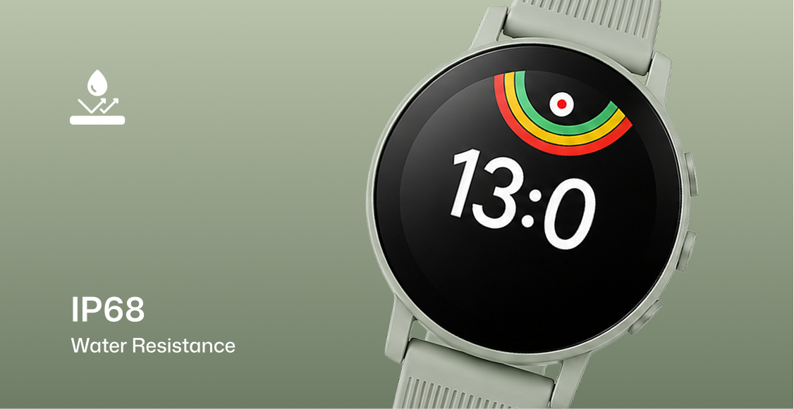 A smartwatch with a round black display and a light gray or off-white silicone strap, shown on a muted green background. The watch face displays the time 13:0 and a small multicolor ring graphic.