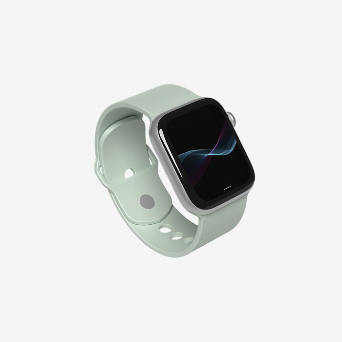 A smartwatch with a light sage green sport band and a silver-toned case, shown at an angle on a clean, light gray background.